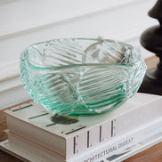Textured clear blue decorative glass bowl inspired by glacial ice with a sculptural design for modern luxury interiors.
