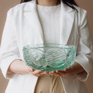 Textured clear blue decorative glass bowl inspired by glacial ice with a sculptural design for modern luxury interiors.
