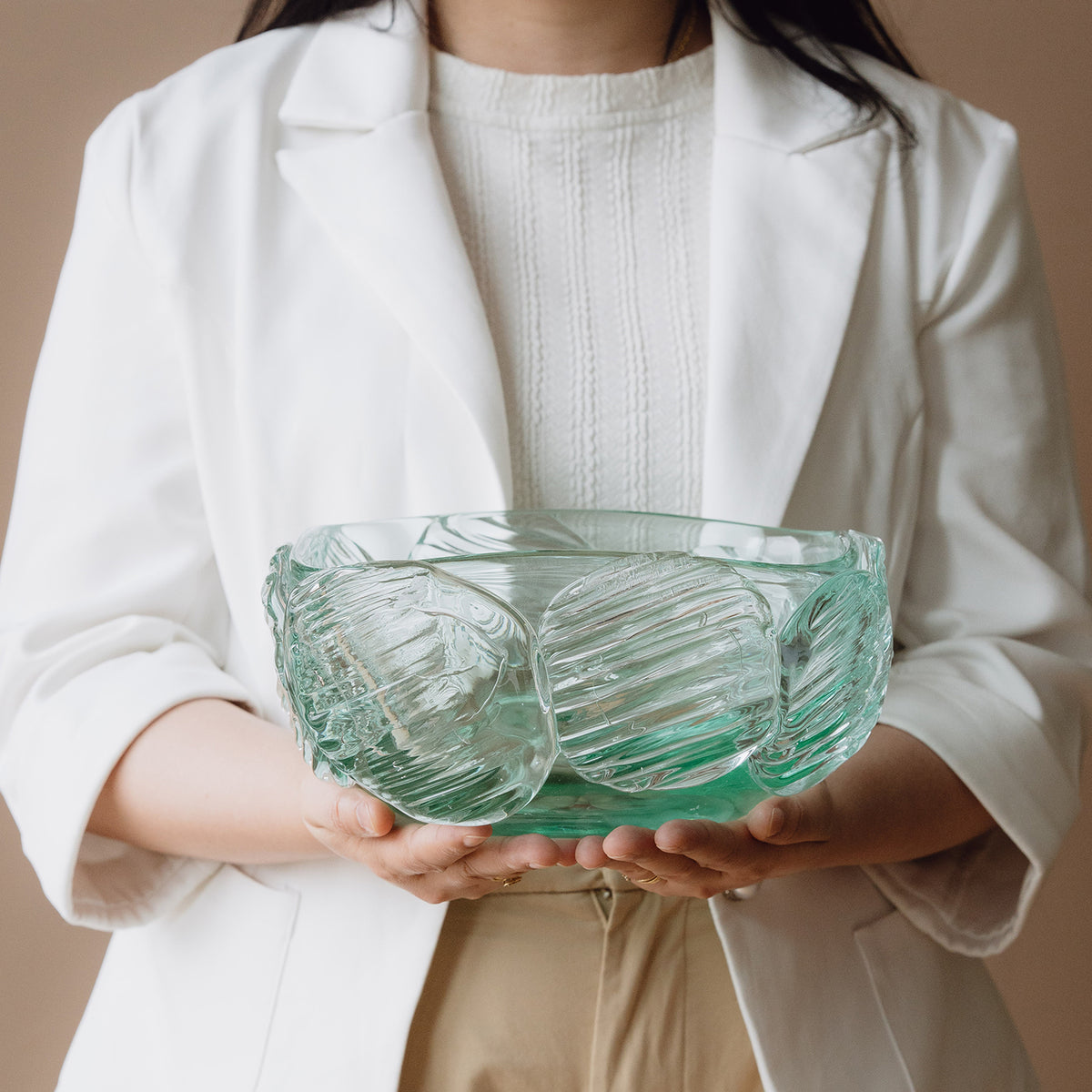 Textured clear blue decorative glass bowl inspired by glacial ice with a sculptural design for modern luxury interiors.