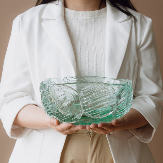 Textured clear blue decorative glass bowl inspired by glacial ice with a sculptural design for modern luxury interiors.