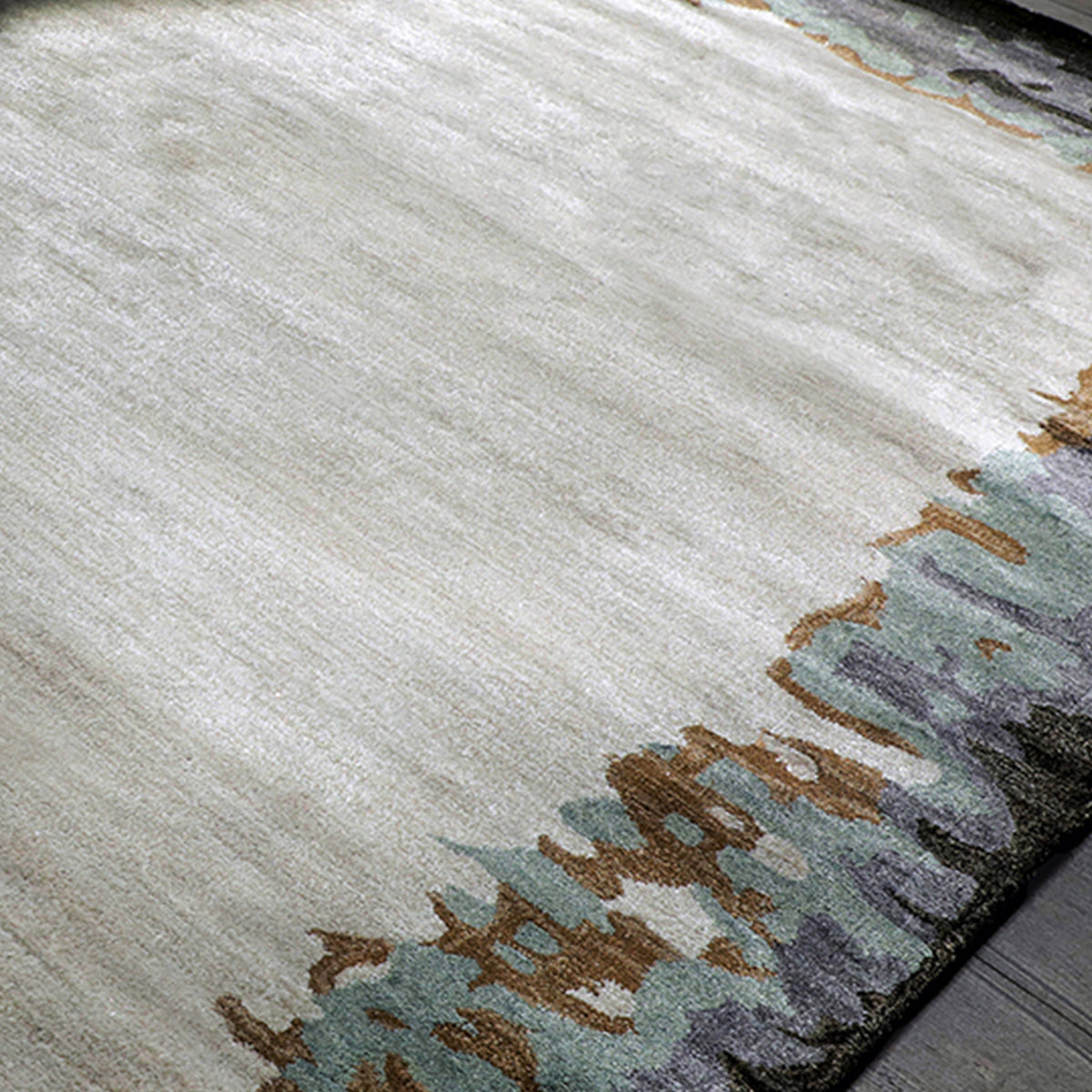 Handmade bamboo silk rug with abstract layered gold, green, and grey tones on a contemporary design.
