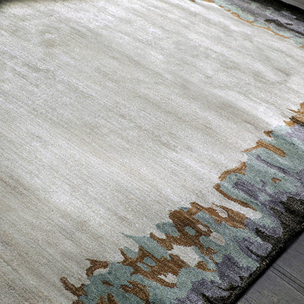 Handmade bamboo silk rug with abstract layered gold, green, and grey tones on a contemporary design.