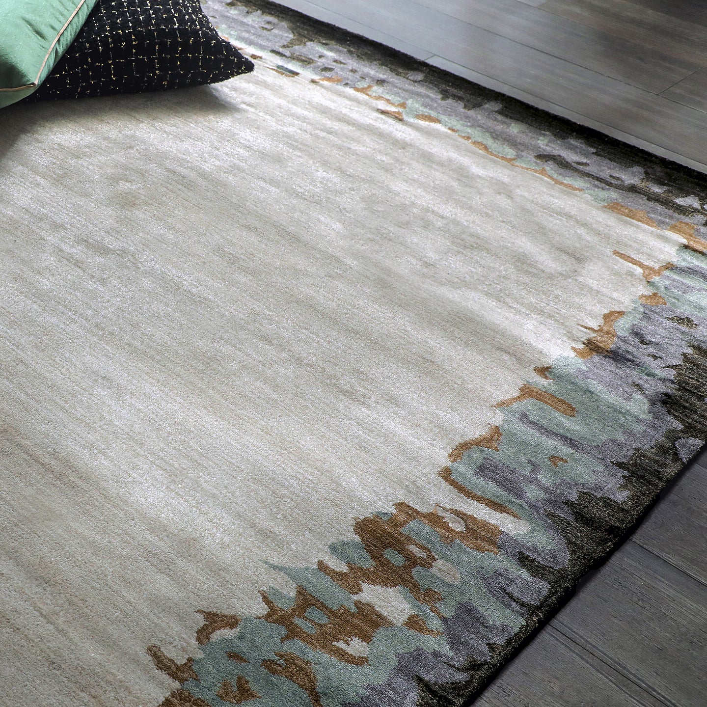 Handmade bamboo silk rug with abstract layered gold, green, and grey tones on a contemporary design.
