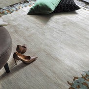 Handmade bamboo silk rug with abstract layered gold, green, and grey tones on a contemporary design.