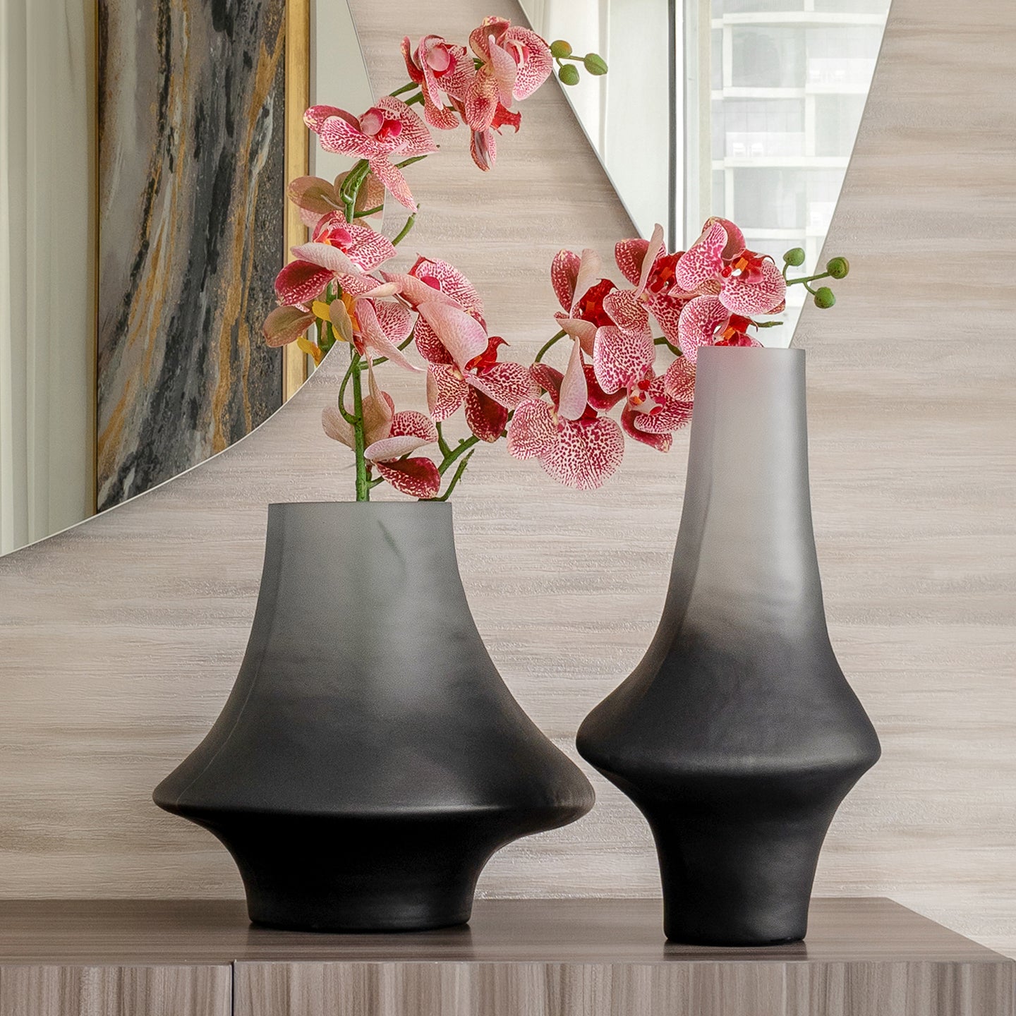 Decorative glass vase with a grey ombre finish and sculptural organic silhouette for contemporary and luxury interiors.