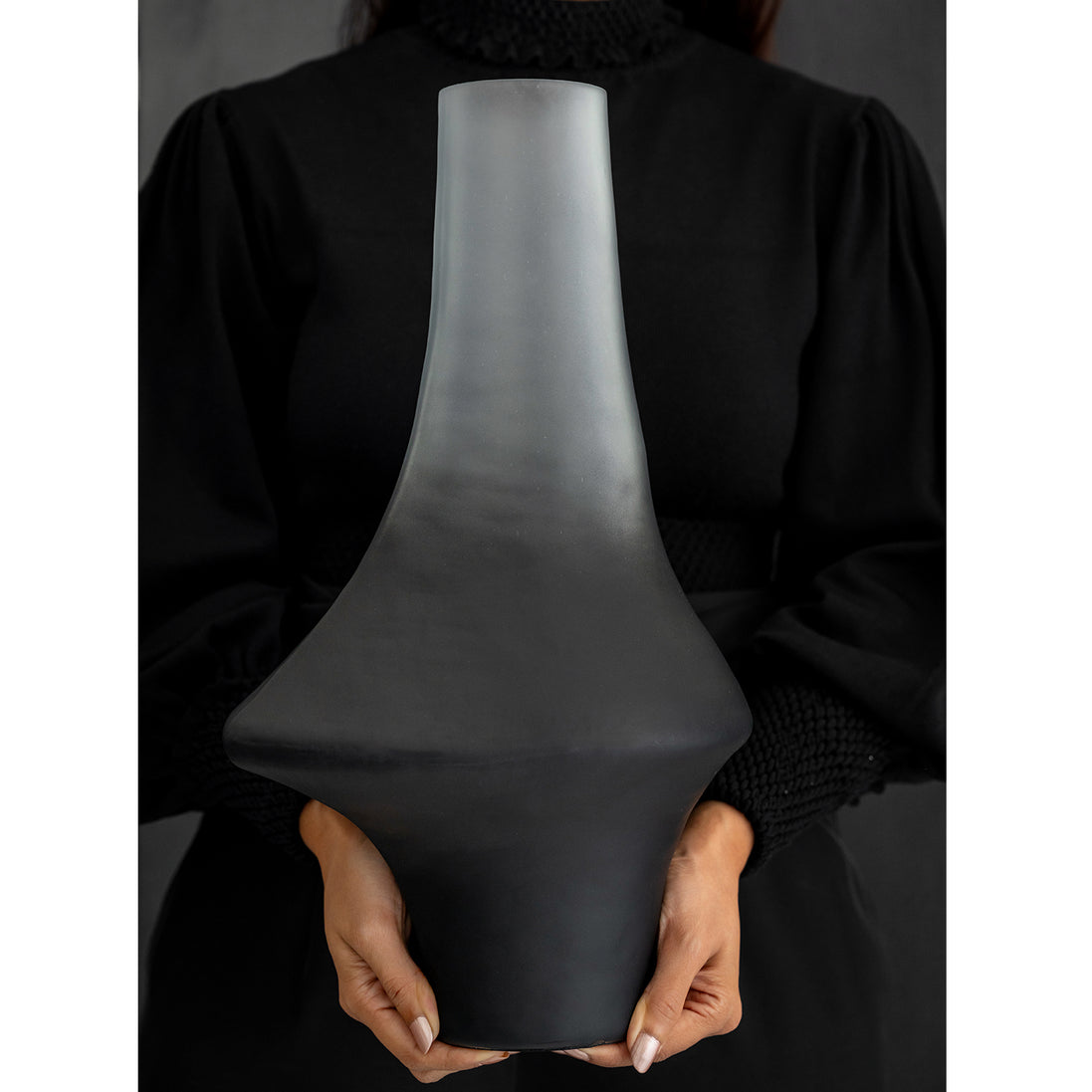 Decorative glass vase with a grey ombre finish and sculptural organic silhouette for contemporary and luxury interiors.
