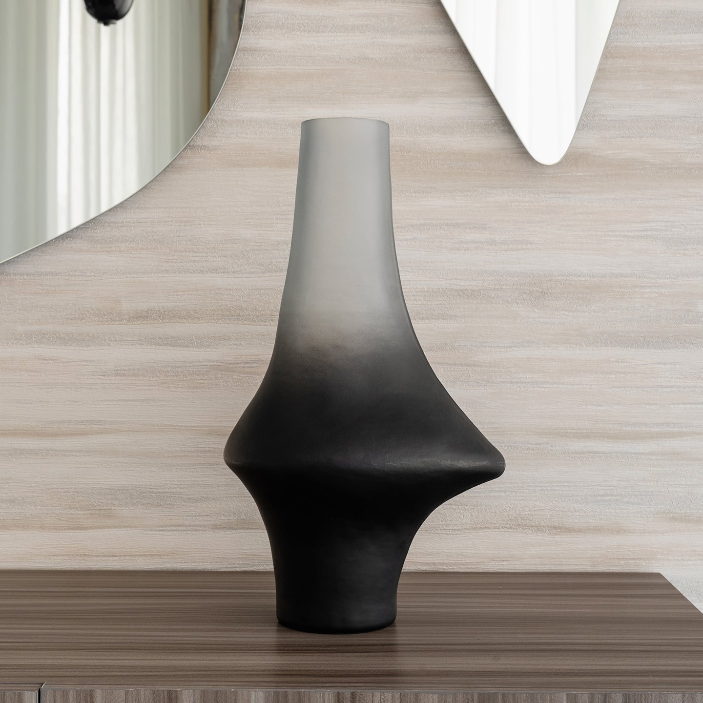 Decorative glass vase with a grey ombre finish and sculptural organic silhouette for contemporary and luxury interiors.