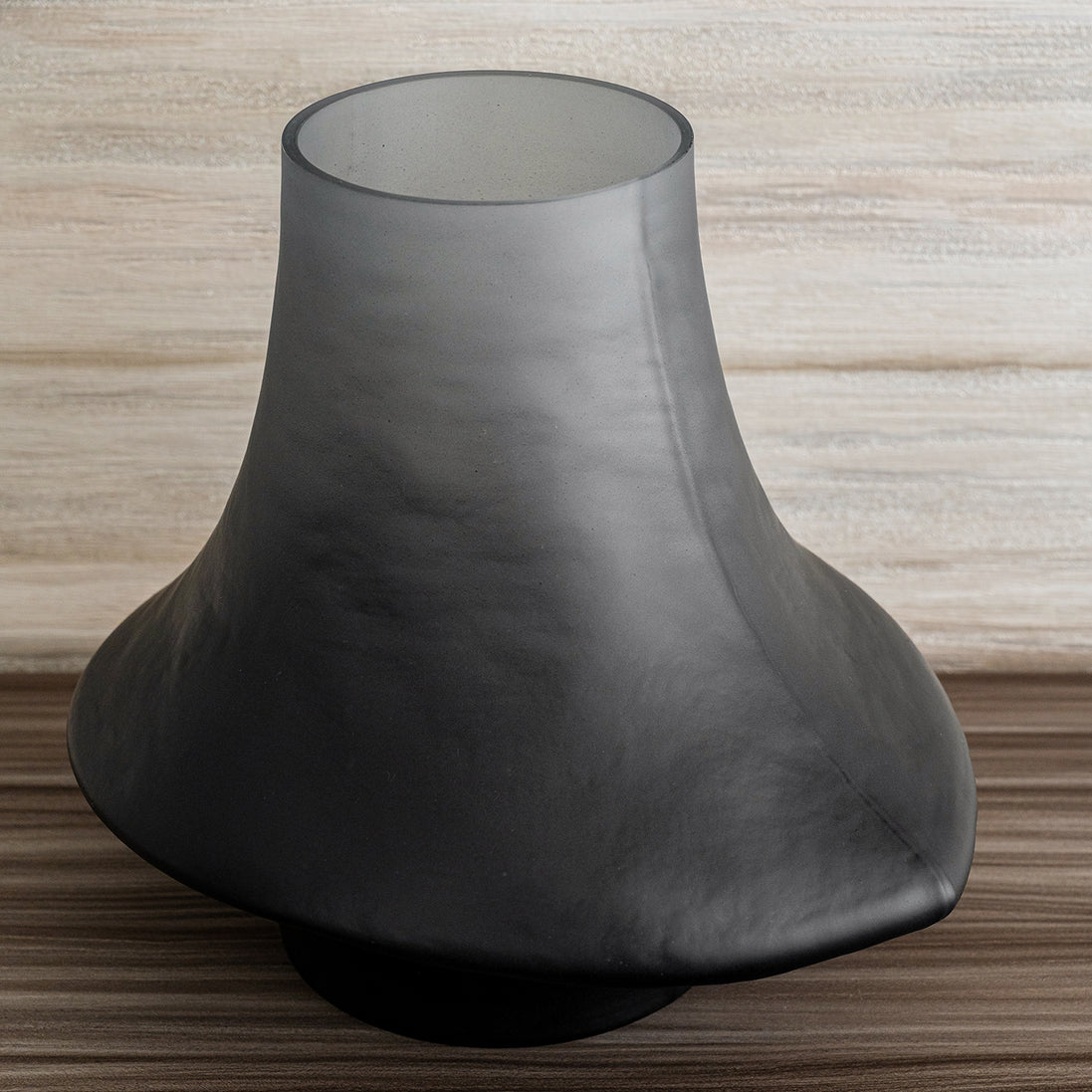 Decorative glass vase with a grey ombre finish and sculptural organic silhouette for contemporary and luxury interiors.