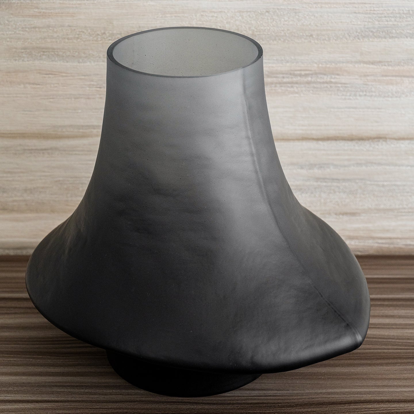 Decorative glass vase with a grey ombre finish and sculptural organic silhouette for contemporary and luxury interiors.