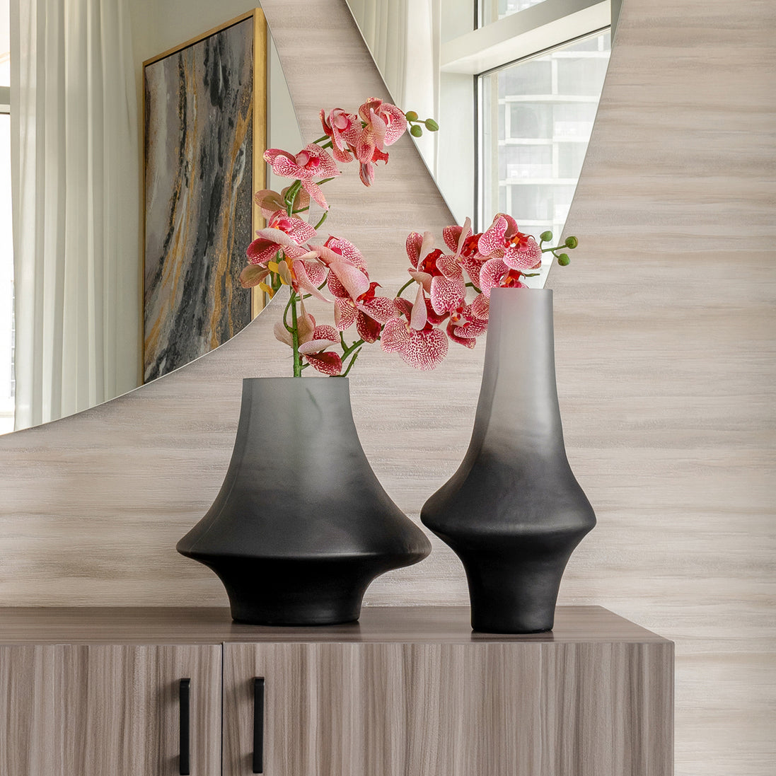 Decorative glass vase with a grey ombre finish and sculptural organic silhouette for contemporary and luxury interiors.