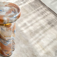 Clover swirl accent table with clover-shaped base and pastel tones, luxury designer side table for modern home décor