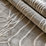 Handmade textured rug with sculpted high-pile waves in an organic pattern for contemporary and luxury interiors.