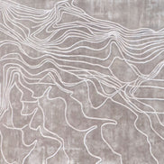 Handmade textured rug with sculpted high-pile waves in an organic pattern for contemporary and luxury interiors.
