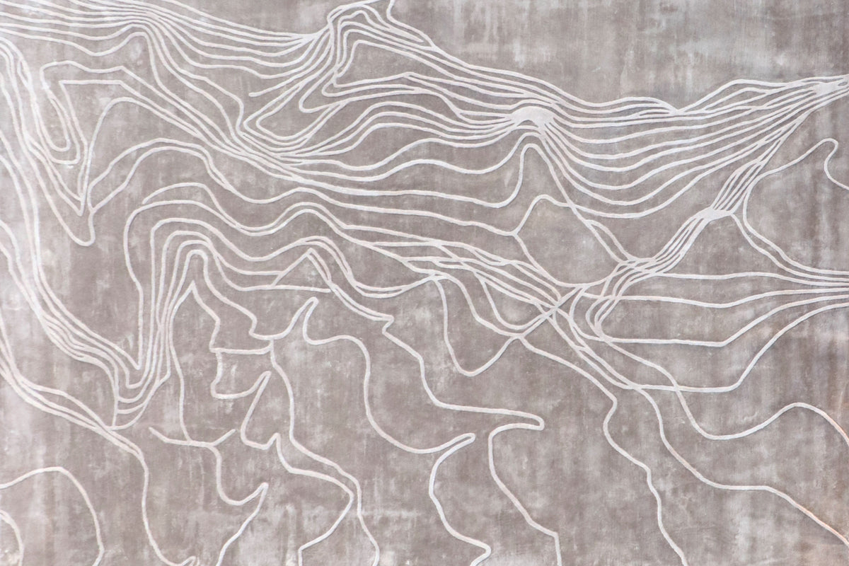 Handmade textured rug with sculpted high-pile waves in an organic pattern for contemporary and luxury interiors.