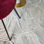 Handmade textured rug with sculpted high-pile waves in an organic pattern for contemporary and luxury interiors.
