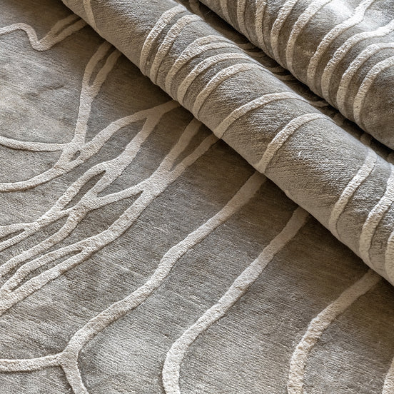 Handmade textured rug with sculpted high-pile waves in an organic pattern for contemporary and luxury interiors.