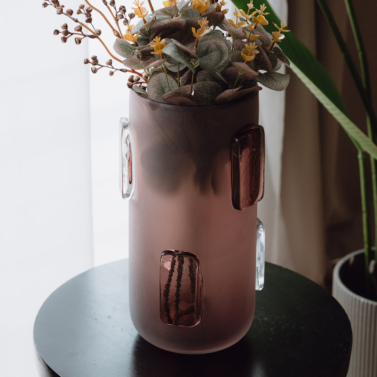 Frosted deep red decorative glass vase with a sleek cylindrical silhouette and glossy accents for contemporary luxury interiors.