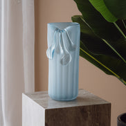 Frosted light blue decorative glass vase with a sculptural flowing silhouette for contemporary and luxury interiors.