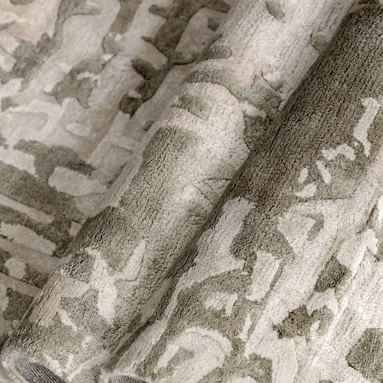 Handmade bamboo silk rug with an abstract design in warm beige and cream tones for contemporary and luxury interiors.