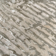Handmade bamboo silk rug with an abstract design in warm beige and cream tones for contemporary and luxury interiors.