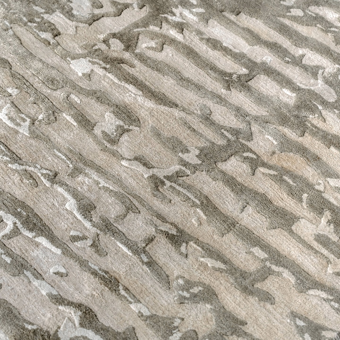 Handmade bamboo silk rug with an abstract design in warm beige and cream tones for contemporary and luxury interiors.