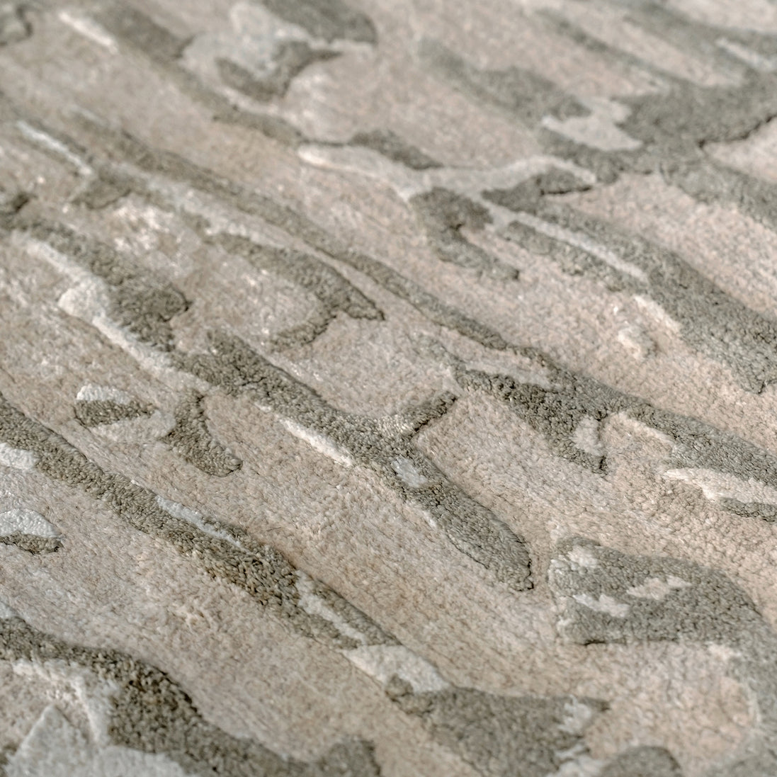 Handmade bamboo silk rug with an abstract design in warm beige and cream tones for contemporary and luxury interiors.