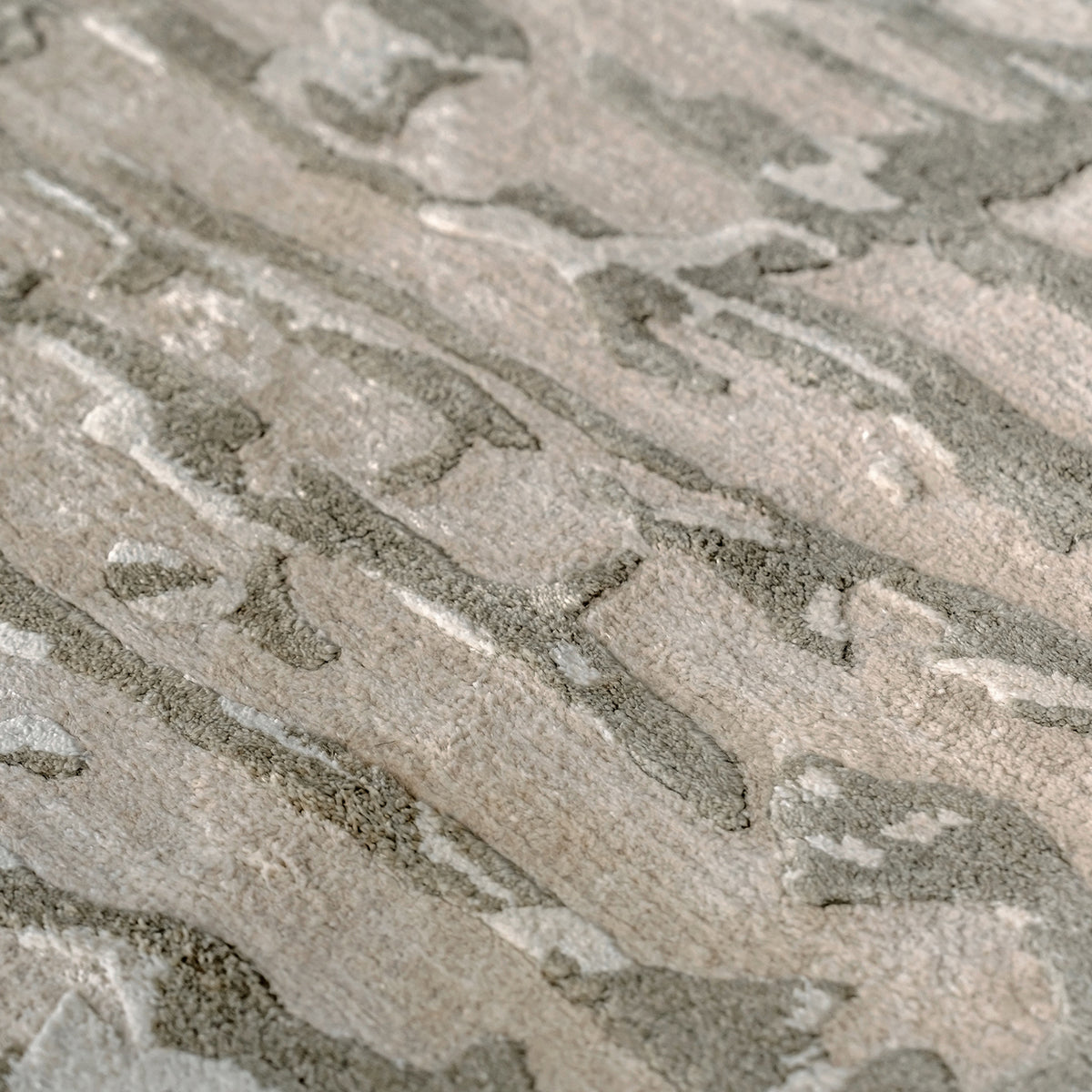 Handmade bamboo silk rug with an abstract design in warm beige and cream tones for contemporary and luxury interiors.