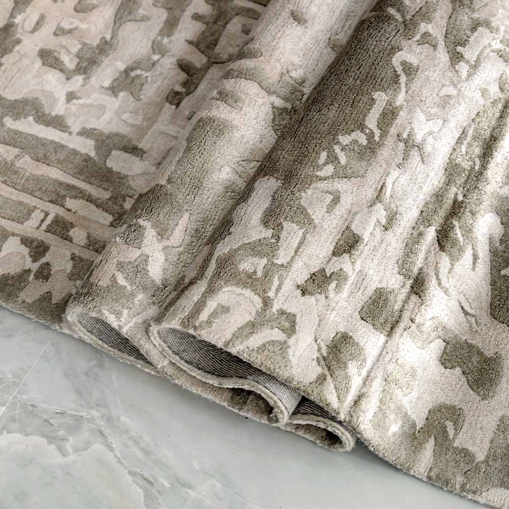 Handmade bamboo silk rug with an abstract design in warm beige and cream tones for contemporary and luxury interiors.