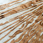Handmade abstract rug with deep rust tones and a cream base, designed for modern and transitional luxury interiors.