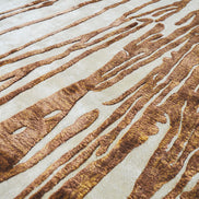 Handmade abstract rug with deep rust tones and a cream base, designed for modern and transitional luxury interiors.