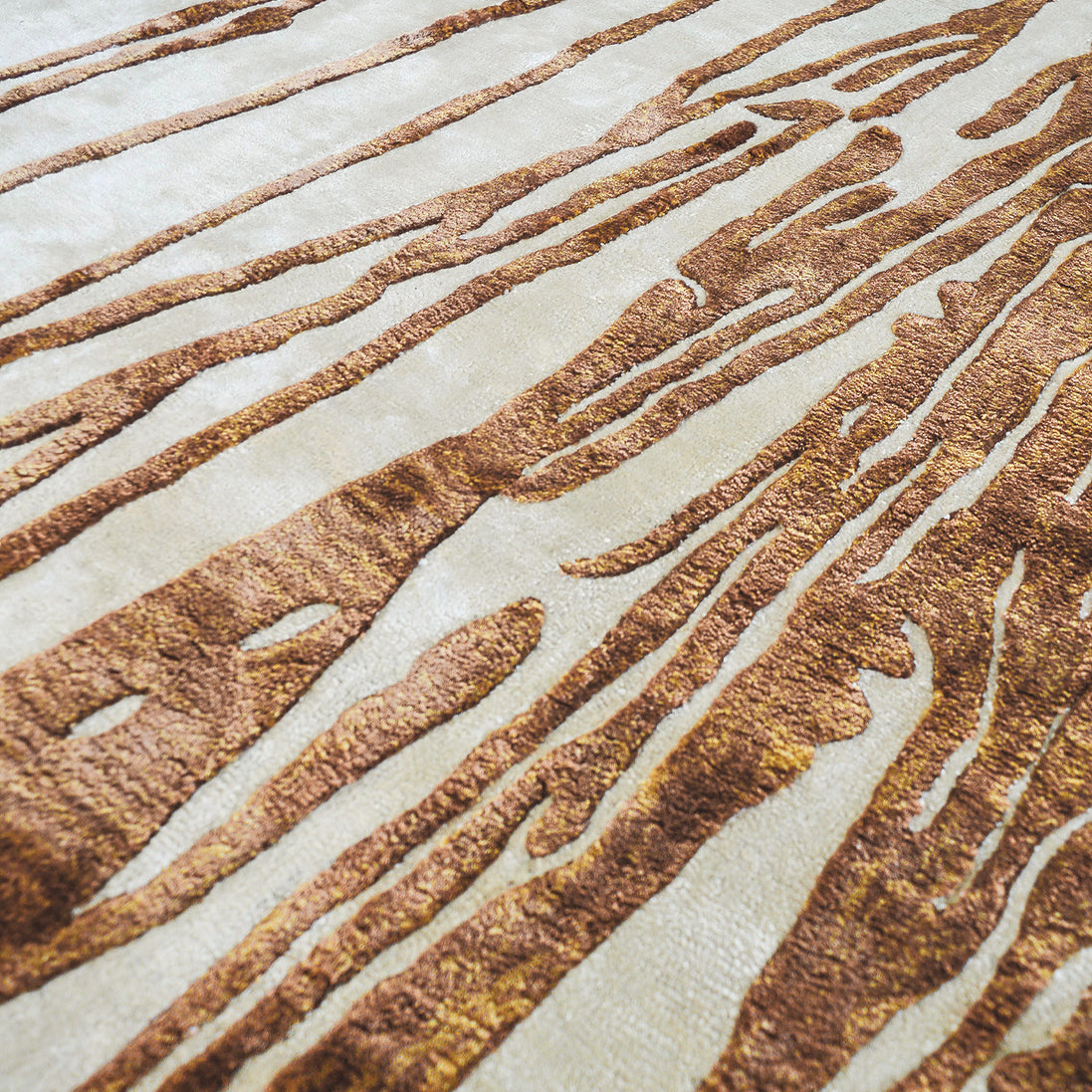 Handmade abstract rug with deep rust tones and a cream base, designed for modern and transitional luxury interiors.