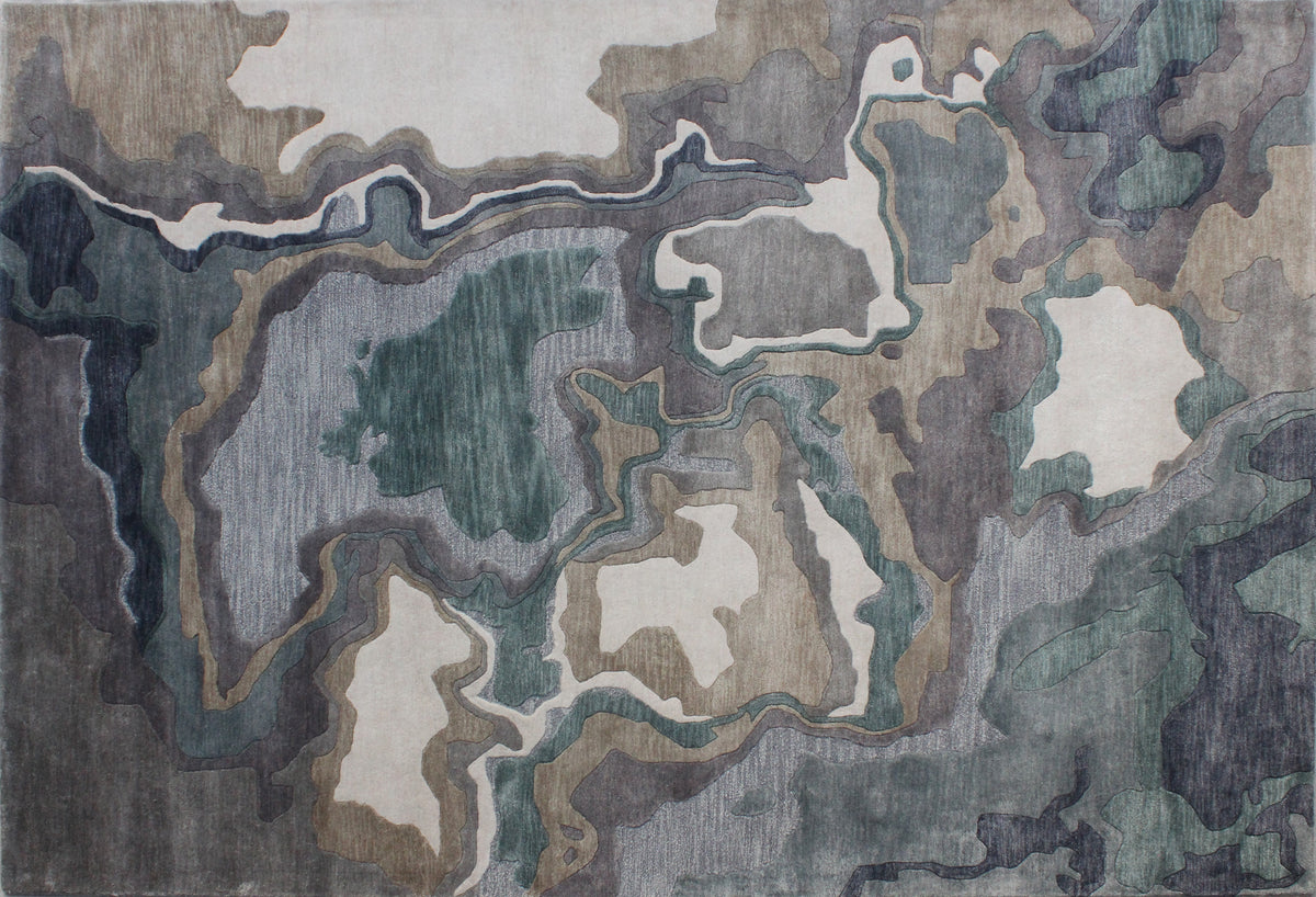 Handmade bamboo silk rug with textured organic motifs in soft blue, deep green, and neutral tones inspired by flowing water.