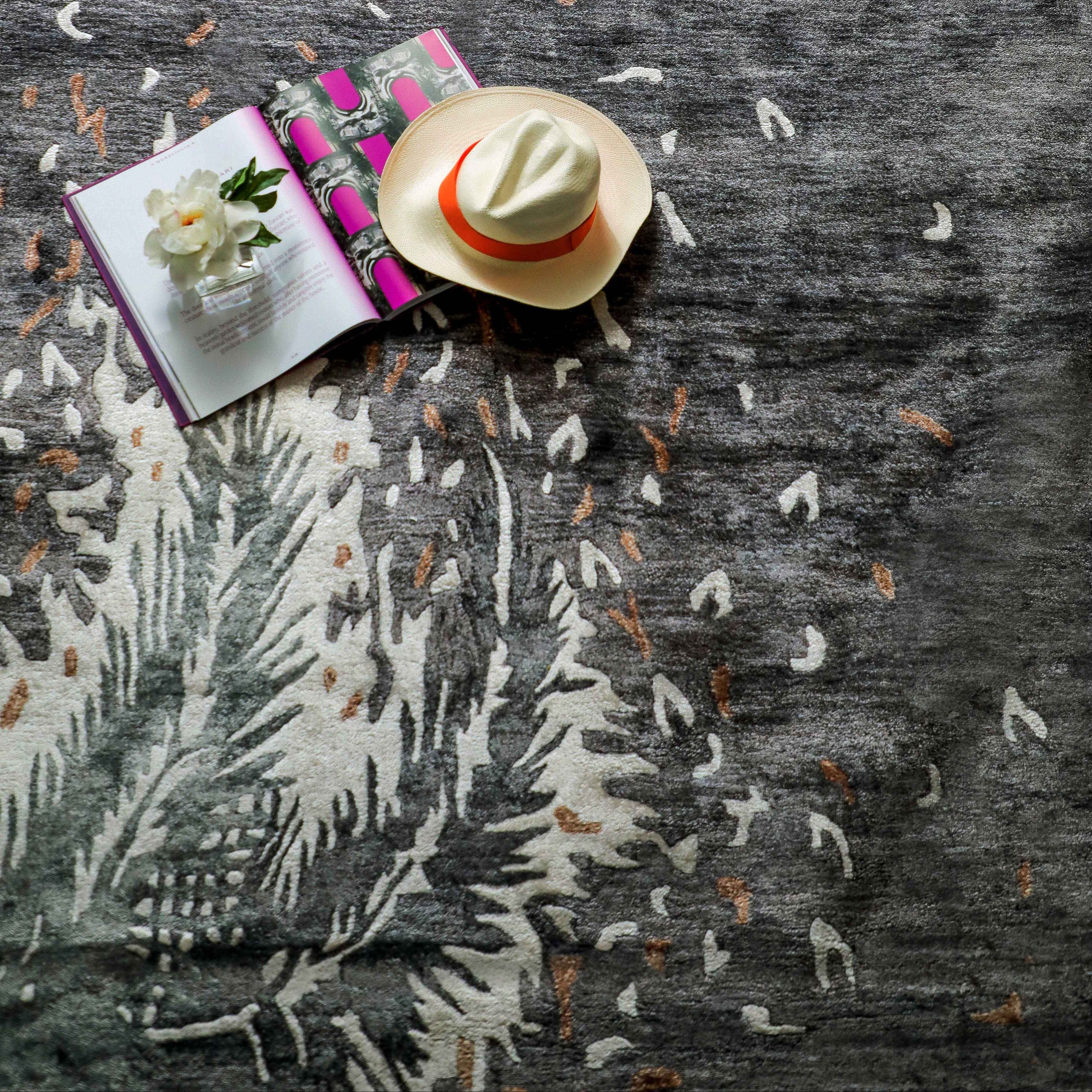 Handmade botanical rug inspired by UAE palm leaves with delicate leaf motifs fading into soft scattered flecks of colour.