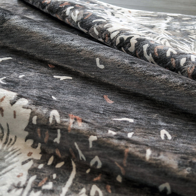 Handmade botanical rug inspired by UAE palm leaves with delicate leaf motifs fading into soft scattered flecks of colour.
