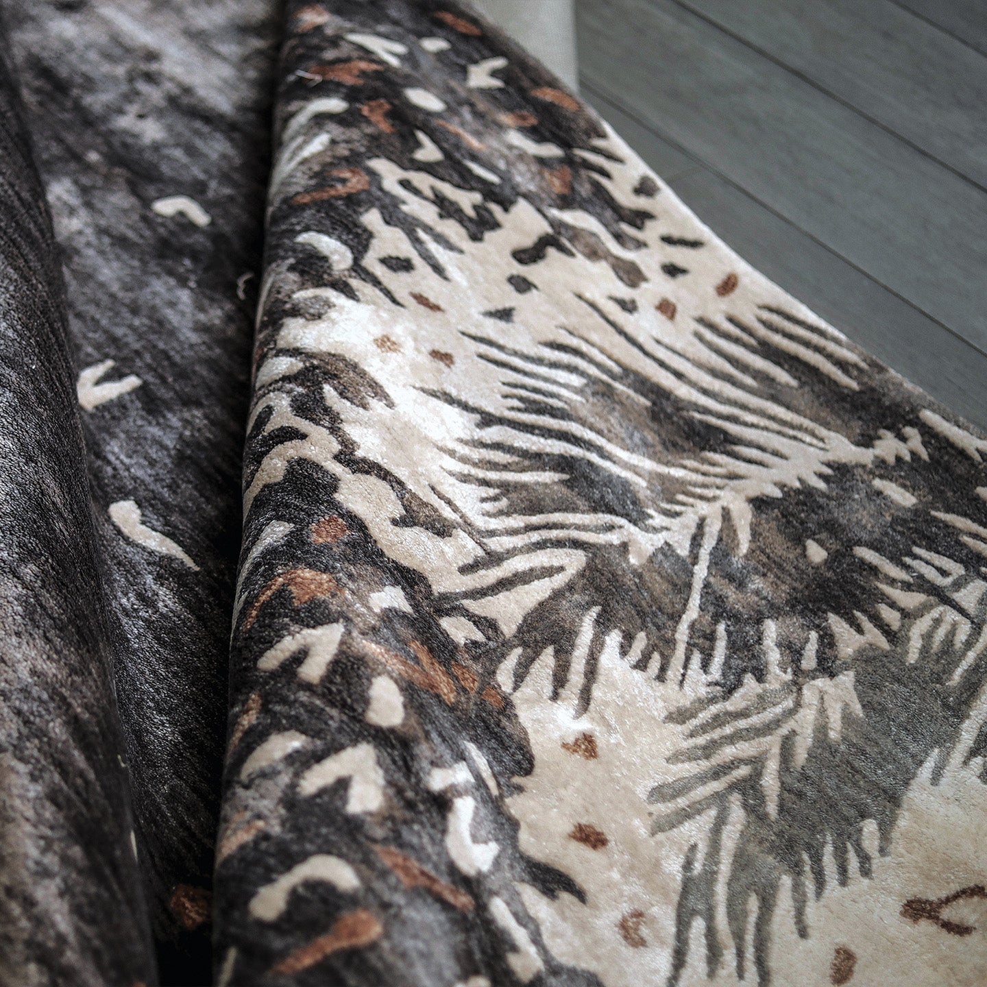 Handmade botanical rug inspired by UAE palm leaves with delicate leaf motifs fading into soft scattered flecks of colour.