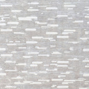 Handmade geometric rug with a textured monotone design and varying pile heights for contemporary luxury interiors.