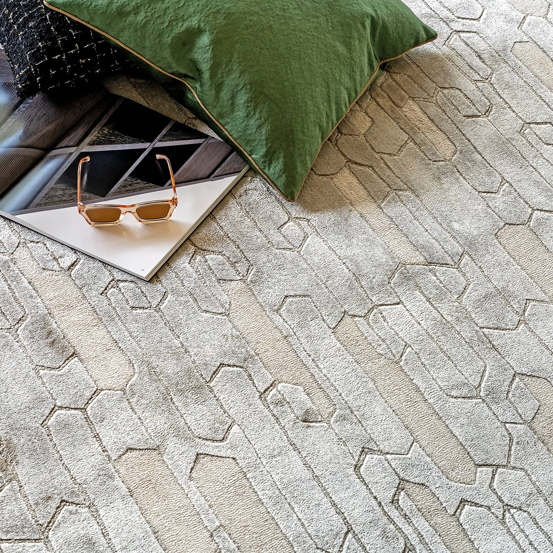 Handmade geometric rug with a textured monotone design and varying pile heights for contemporary luxury interiors.