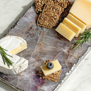 Kristal amethyst stone platter with organic shape and silver edge, luxury natural stone serving platter for elegant entertaining and décor.