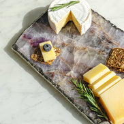 Kristal amethyst stone platter with organic shape and silver edge, luxury natural stone serving platter for elegant entertaining and décor.