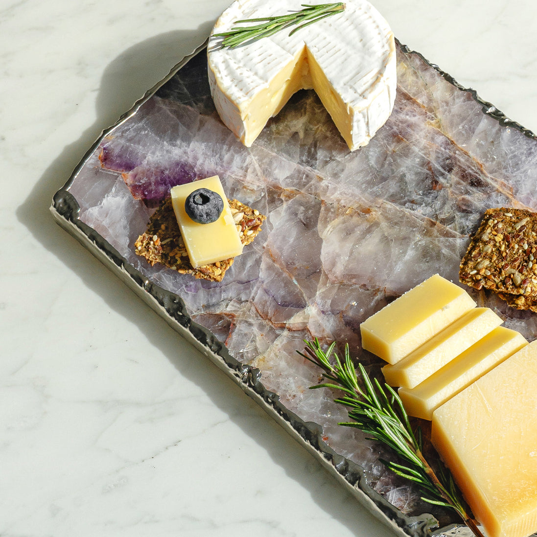 Kristal amethyst stone platter with organic shape and silver edge, luxury natural stone serving platter for elegant entertaining and décor.