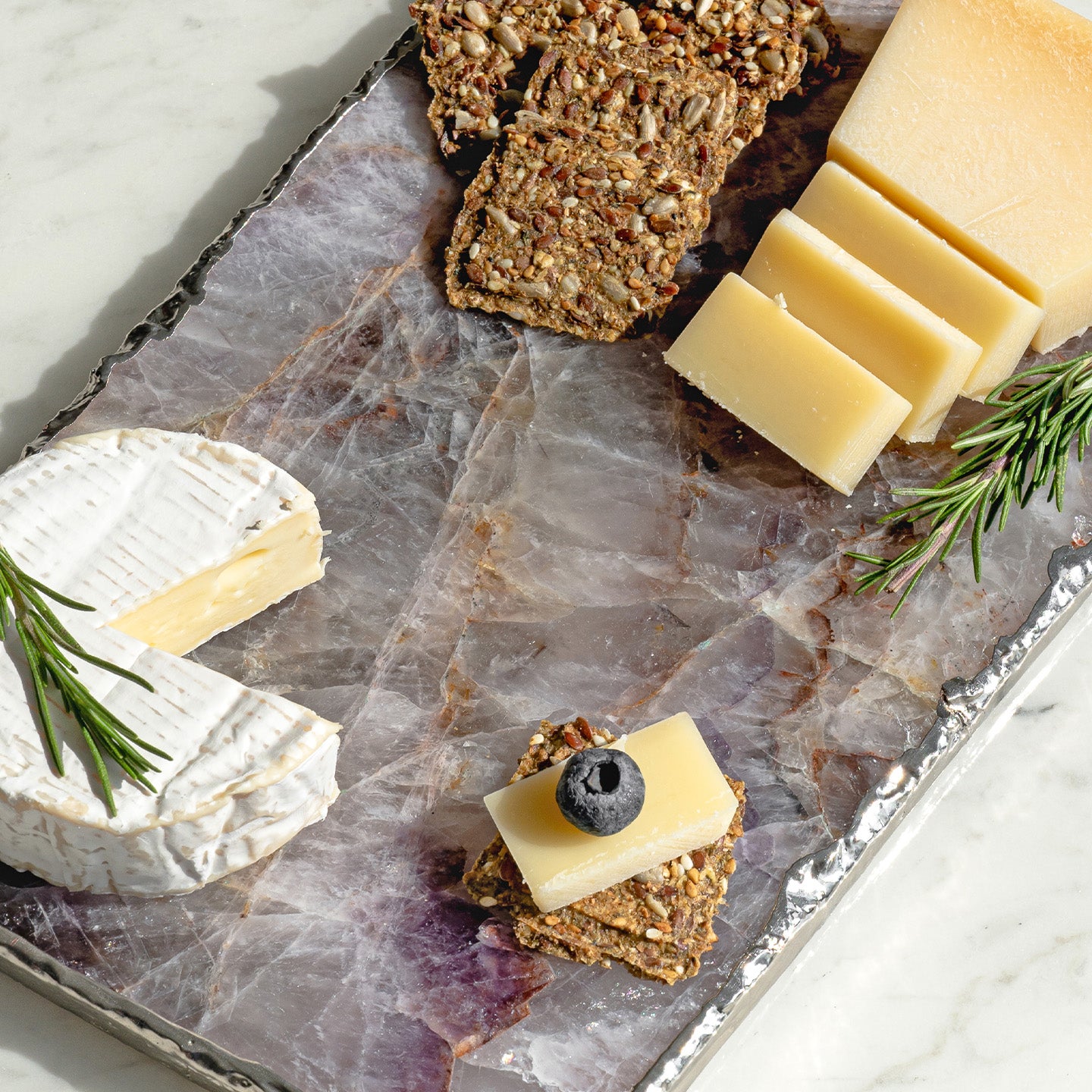 Kristal amethyst stone platter with organic shape and silver edge, luxury natural stone serving platter for elegant entertaining and décor.