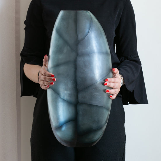 Hand-blown glass vase in ocean and indigo blue with a hand-finished design, available in two sizes for modern luxury interiors.