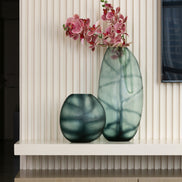 Hand-blown glass vase in ocean and indigo blue with a hand-finished design, available in two sizes for modern luxury interiors.