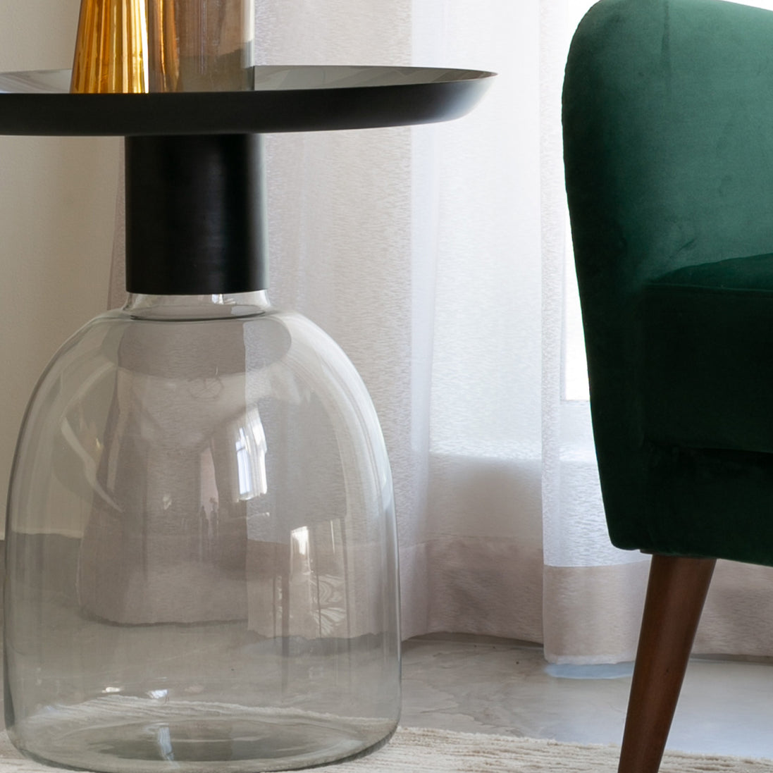 Luxe black and grey glass accent table with handblown glass base and matte black metal finish, modern side table for home décor