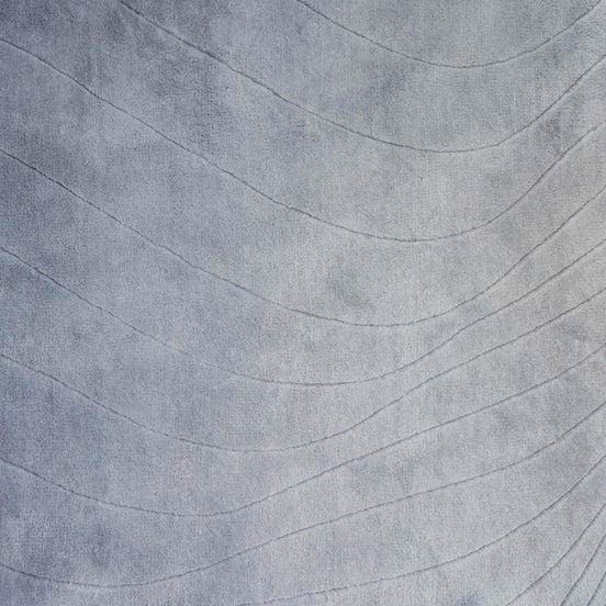 Handmade 100% Tencel rug with embossed wave carvings, subtle tonal texture, and a silky finish for modern luxury interiors.