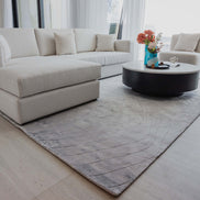 Handmade 100% Tencel rug with embossed wave carvings, subtle tonal texture, and a silky finish for modern luxury interiors.