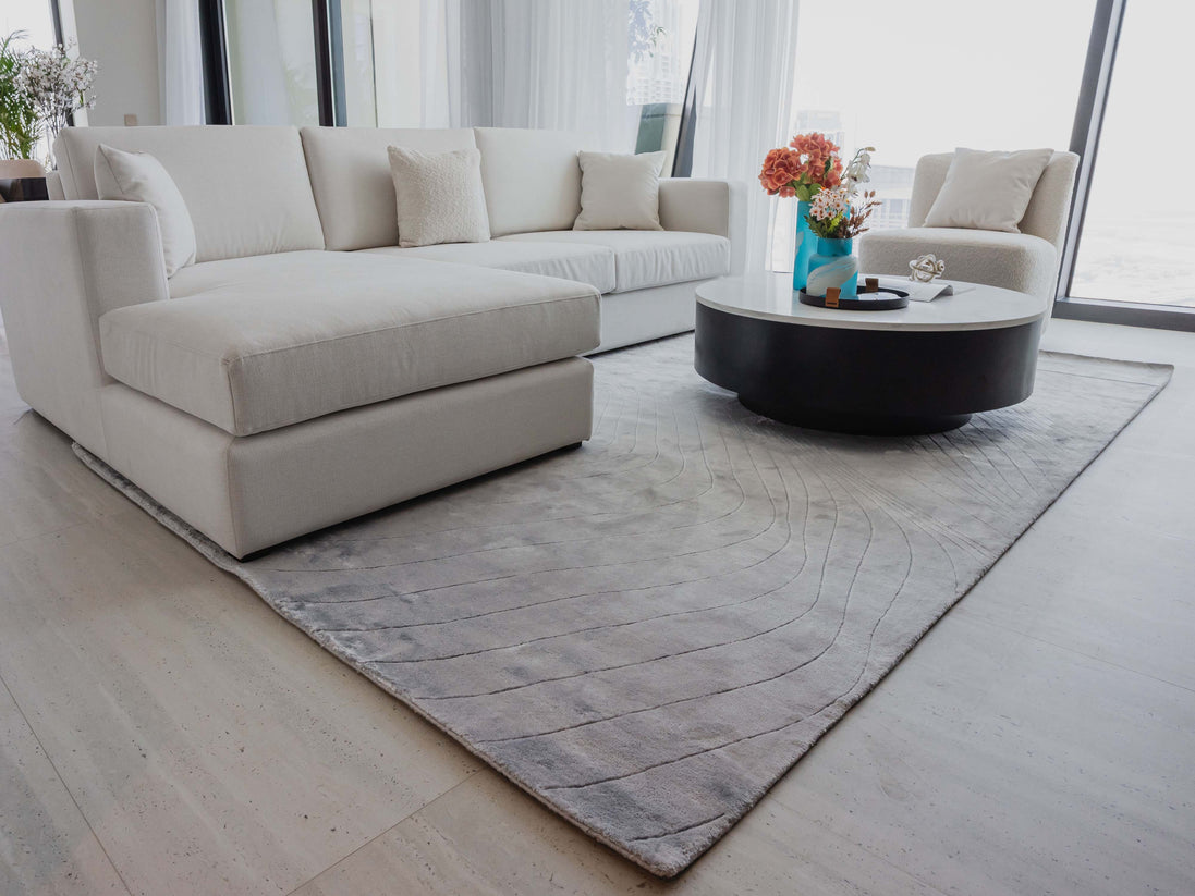 Handmade 100% Tencel rug with embossed wave carvings, subtle tonal texture, and a silky finish for modern luxury interiors.
