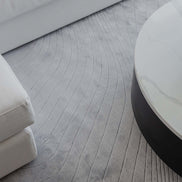 Handmade 100% Tencel rug with embossed wave carvings, subtle tonal texture, and a silky finish for modern luxury interiors.