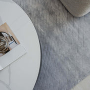 Handmade 100% Tencel rug with embossed wave carvings, subtle tonal texture, and a silky finish for modern luxury interiors.
