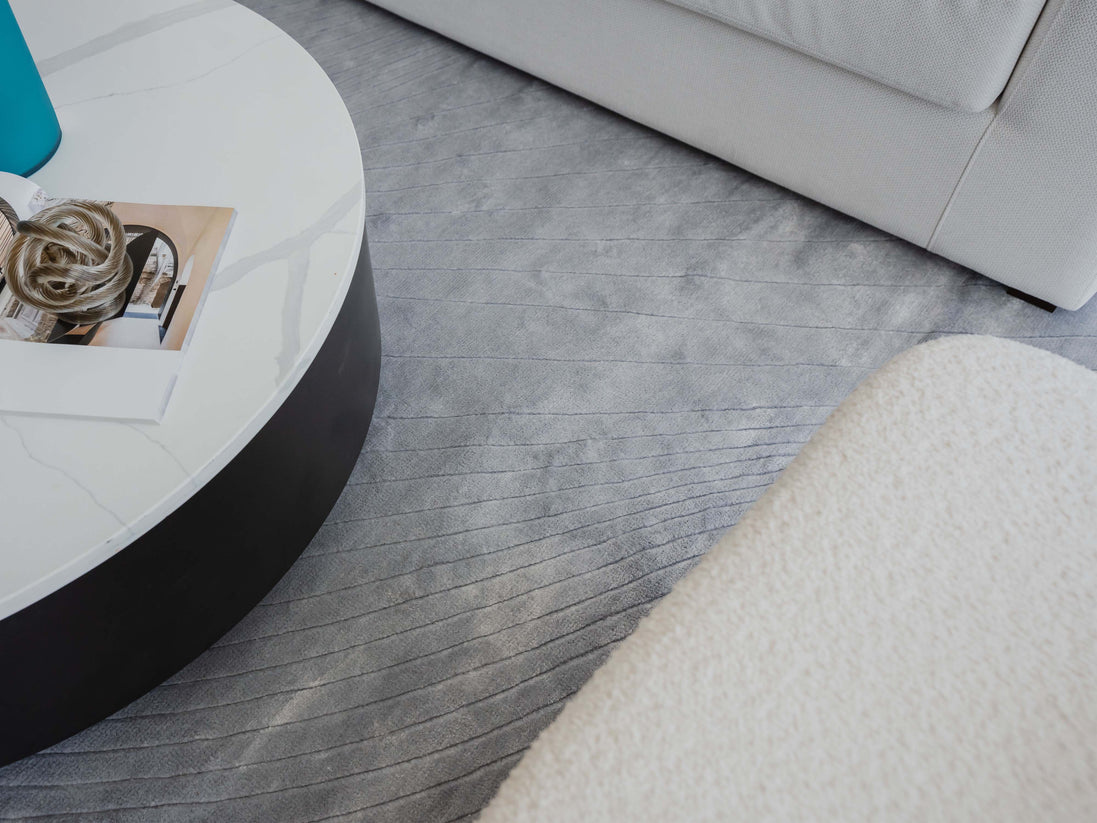 Handmade 100% Tencel rug with embossed wave carvings, subtle tonal texture, and a silky finish for modern luxury interiors.